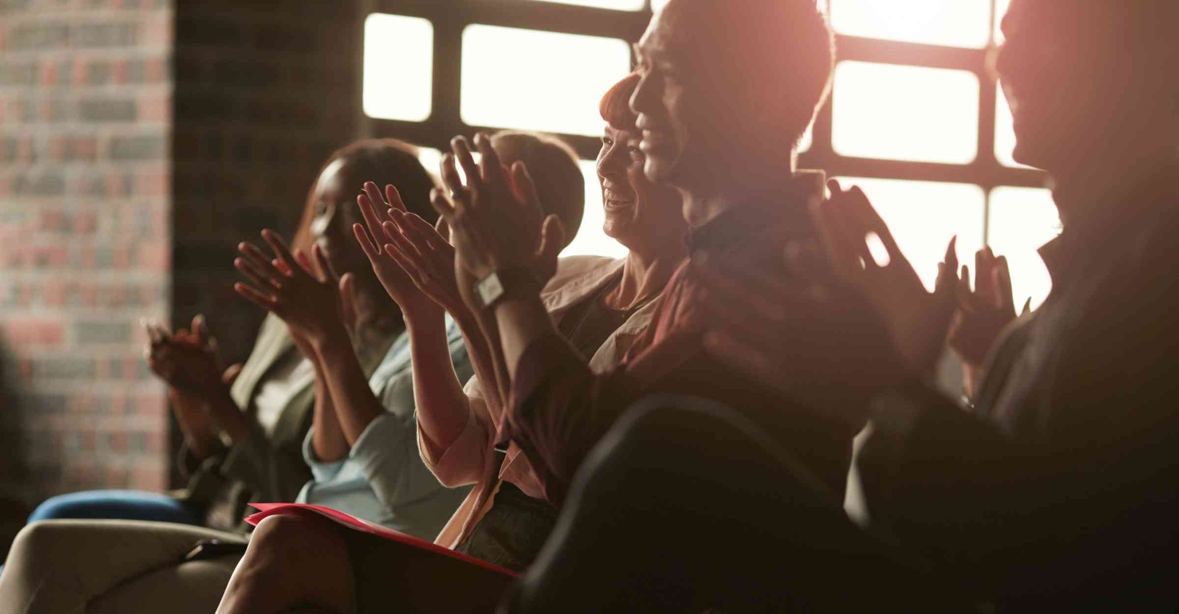 Delegates clapping at a presentation