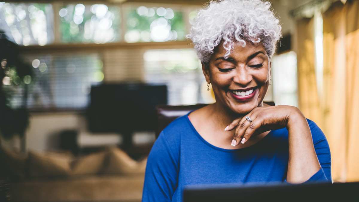 Woman sat at table on laptop