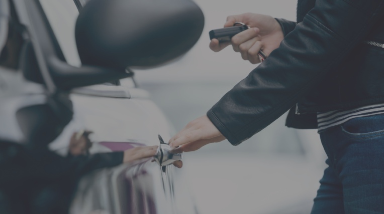 woman opening a car with an electric key clicker